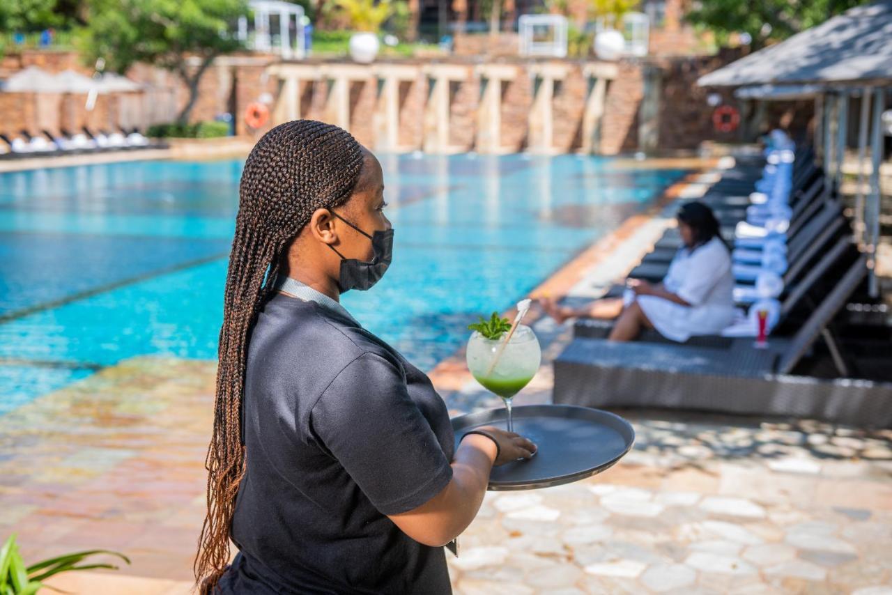 The Capital Zimbali Hotell Ballito Exteriör bild A waitress wearing a face mask at a hotel in Kigali, Rwanda