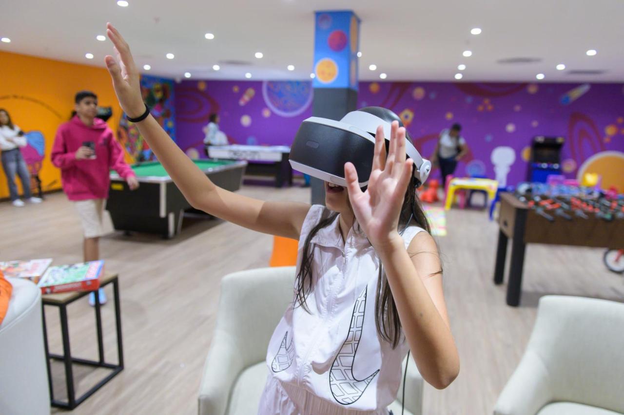 The Capital Zimbali Hotell Ballito Exteriör bild A child using a PlayStation VR headset